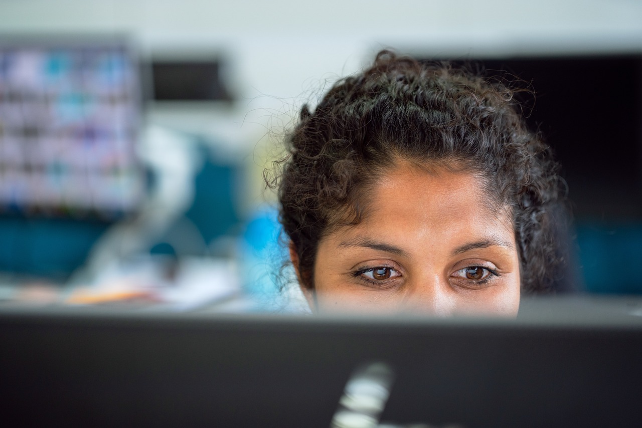 Close crop Payroll integrator working on a computer