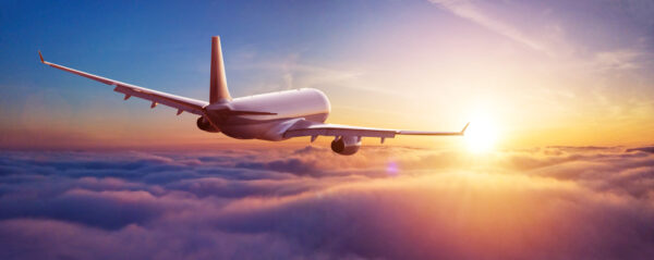 Aircraft in flight towards sunrise banner for HRIS selection, implementation and optimisation blog